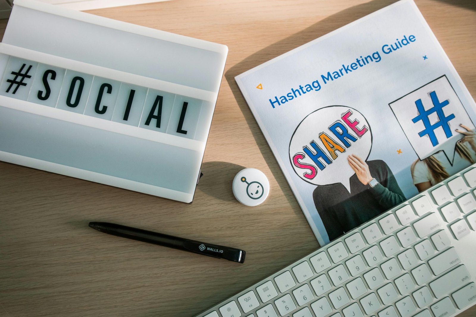 Services A desktop setup with social media marketing essentials including a keyboard, lightbox, and guide.